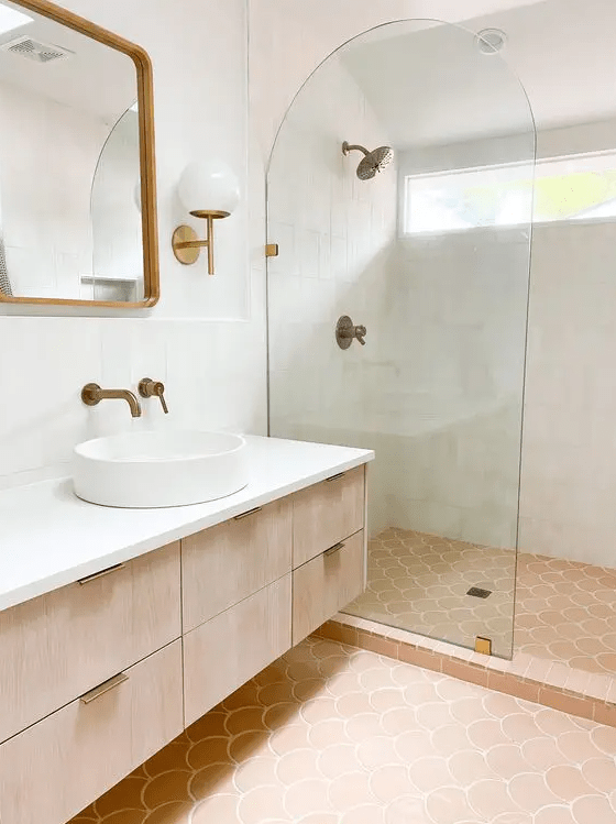 a modern neutral bathroom clad with white Zellige and scallop terracotta tile, a stained vanity, a shower space and a mirror