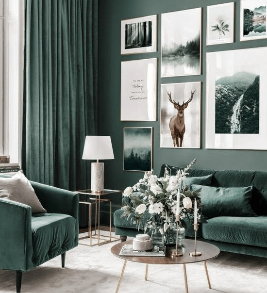 a nature-inspired living room with grey green walls, hunter green furniture and matching curtains and a large gallery wall