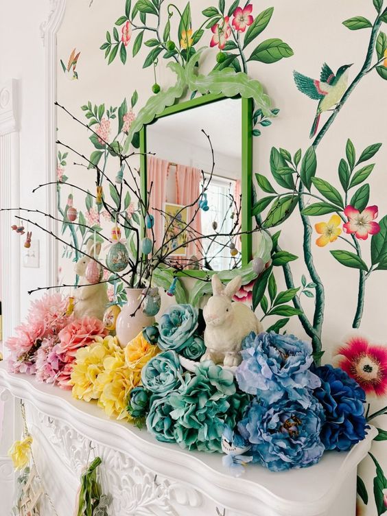 a rainbow Easter mantel with bright faux blooms, bunnies, an Easter egg with pastel eggs hanging is wow