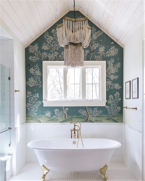 a whimsical bathroom with a planked ceiling, a printed wallpaper wall, a tub, a crystal chandelier and a shower space