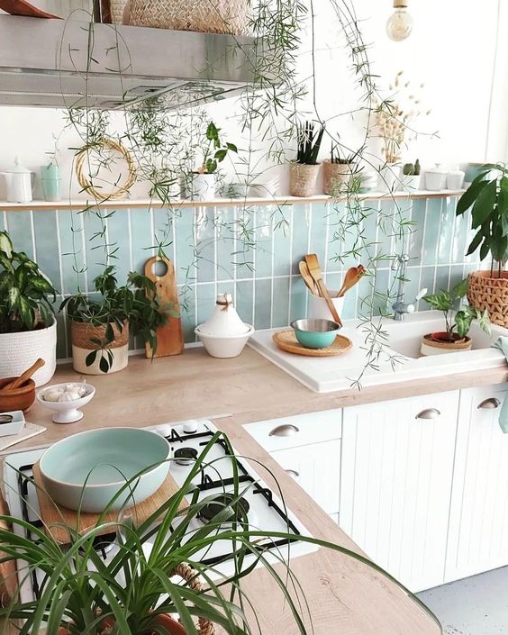 a white planked kitchen with butcherblock countertops, a blue and green Zellige tile backsplash
