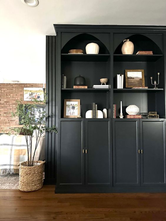 black arched bookcases with decor and candles are great for any modern space and can be used as space dividers