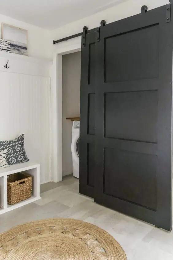Black barn doors make any neutral space more eye catching, even if these are pantry or laundry doors like these ones