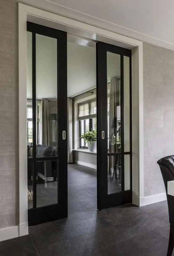 black glass pocket doors are a stylish and cool solution that looks quite lightweight and save a lot of space