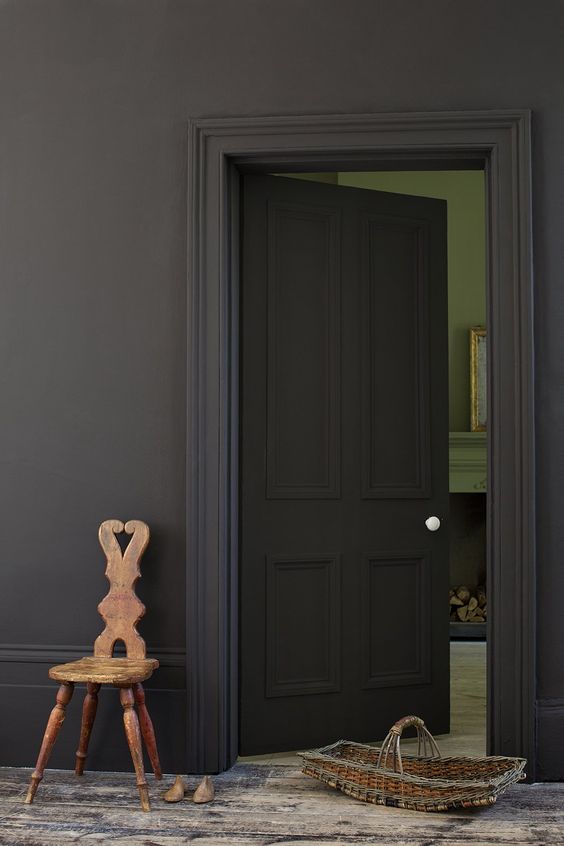matte black walls and a door create a sophisticated moody space, add a rustic shabby chic floor for a contrast