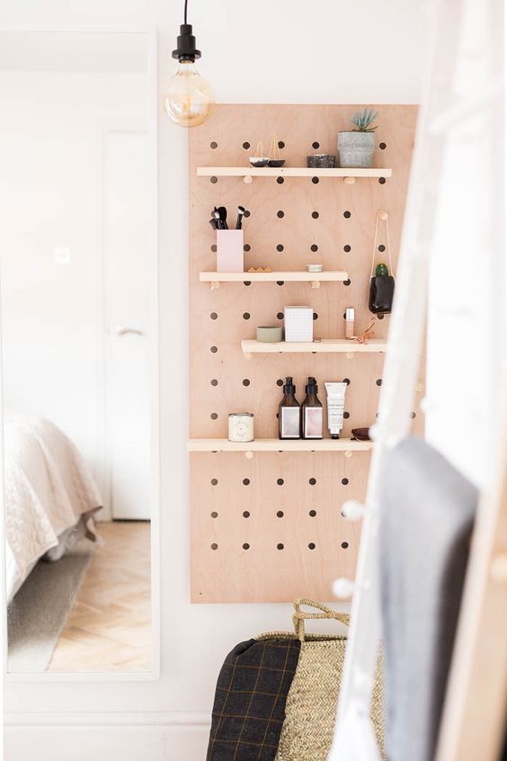 a bathroom organized with a pegboard, with shelves and hooks, is a cool idea, and all your stuff is kep in place