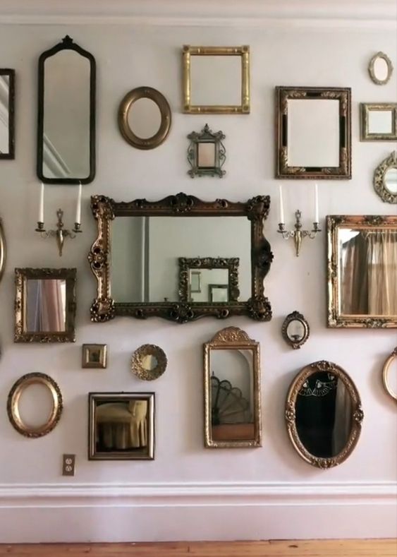 a blank wall styled with a mirror gallery wall in chic and beautiful frames is a gorgeous idea for any space