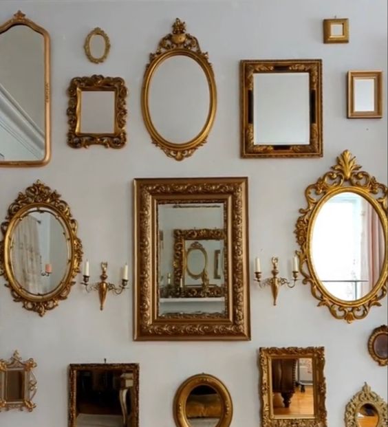 a blank wall with a mirror gallery wall with chic and beautiful gold frames is amazing for decorating any space