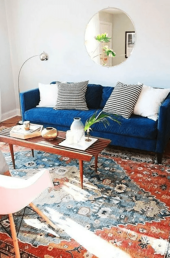 a cozy living room with a blue sofa