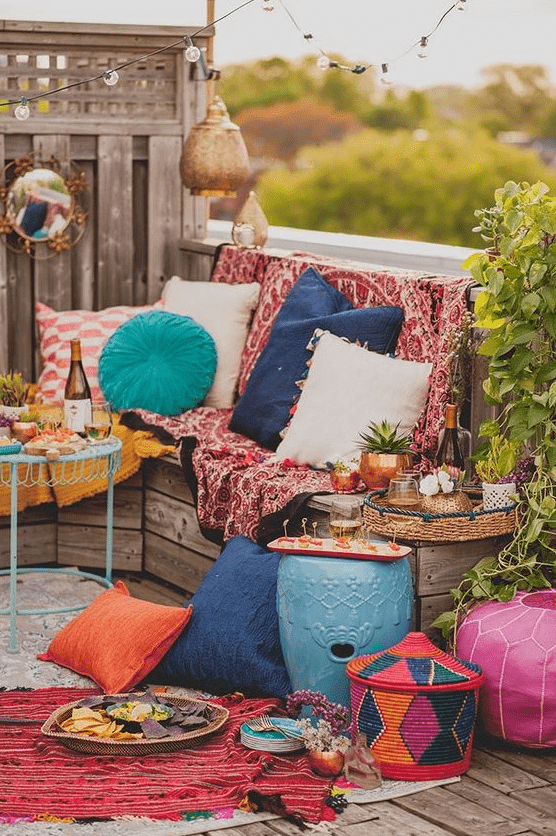 a bright boho Moroccan terrace with colorful textiles, colorful pillows, baskets and colorful fruniture