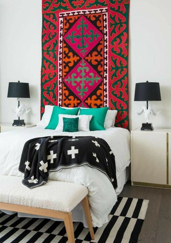 a colorful boho rug makes the black and white space more eye-catching, bold and cool