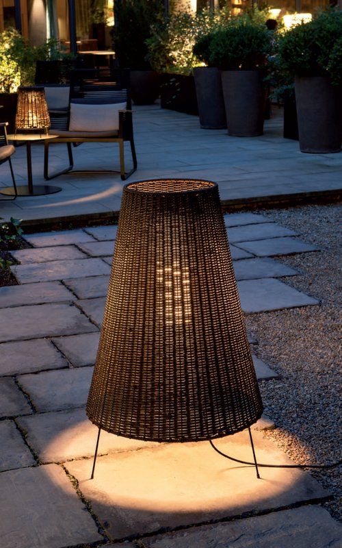 a floor lamp with small legs and a wicker lampshade looks cute and lovely and brings coziness to the outdoor space