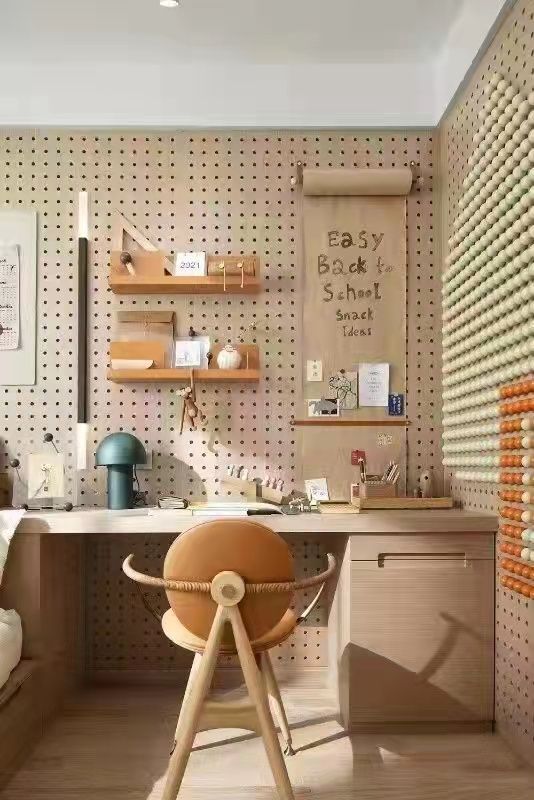 a modern home office done with pegboards, with a stained desk and a chair, some shelves and decor is amazing and cozy