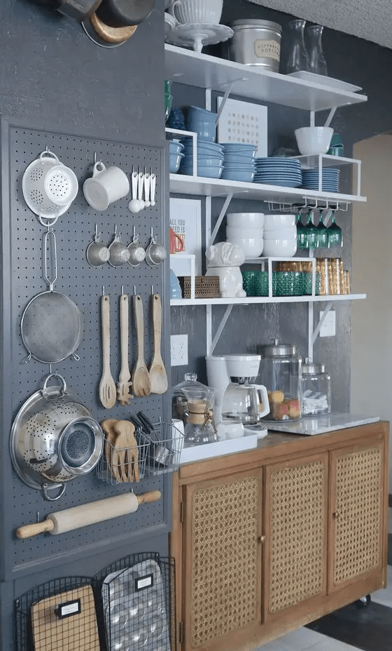 a modern kitchen with a chalkboard pegboard and kitchen ware, cane cabinets and open shelves is very functional
