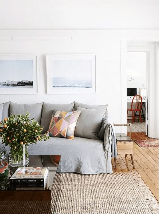 a neutral living room with a grey sofa