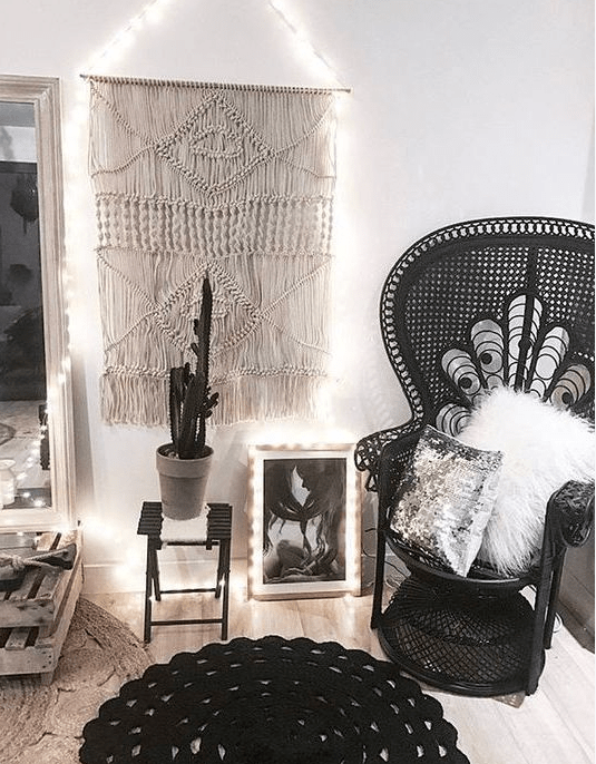 a monochromatic space in boho style with a black peacock chair looks very catchy and is non-traditional for this decor style