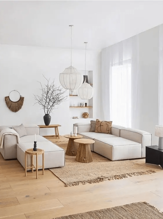 a neutral contemporary living room with low neutral seating furniture, side tables, benches, built-in shelves and chic modern decor