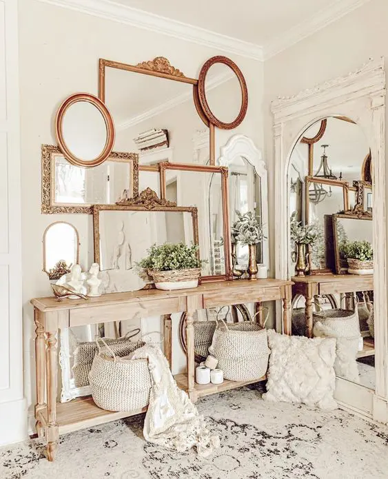 a neutral modern farmhouse space with a stained console table, a mirror gallery wall with chic and refined gold frames plus a large mirror on the wall