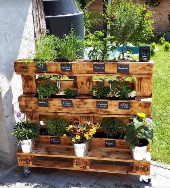 a pallet garden on casters with planters and potted herbs and chalkboard stickers is a smart solution and you can move it anywhere