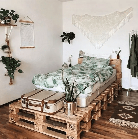 a pallet guest bed with planters and a space for a suitcase is perfect and you can DIY it