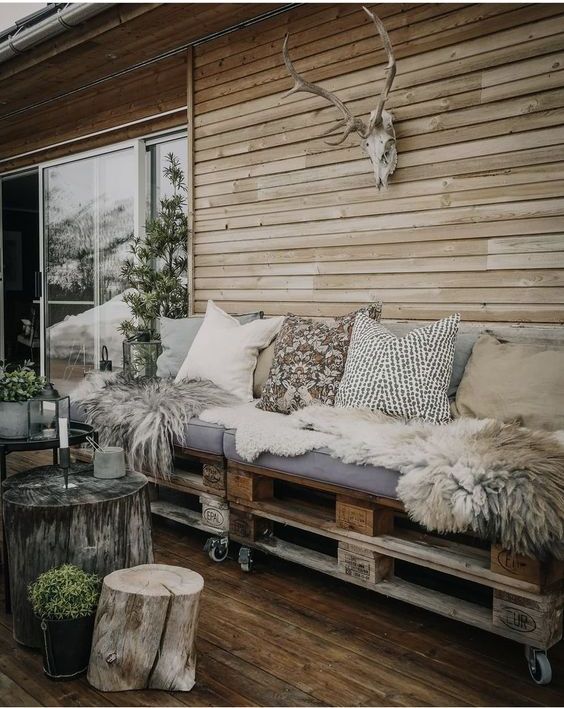 a pallet sofa on casters, with lots of pillows and faux fur is a great solution for a Scandinavian terrace