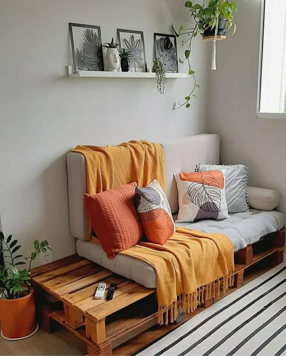a pallet sofa with some cushions and pillows is a cool idea for both indoors and outdoors and you can DIY it