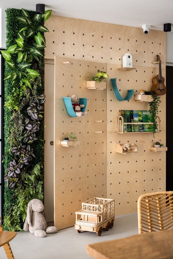 a pegboard covering the wall, with shelves and hooks, with various stuff and greenery covering part of it is a cool idea