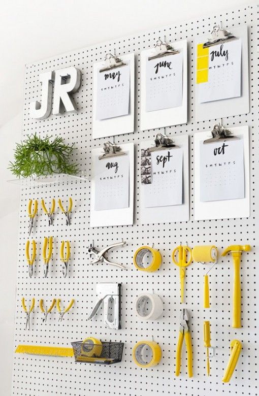 a pegboard for a craft room with some decor and instruments is a smart and cool idea for styling a space