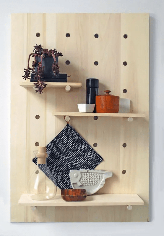 a pegboard with shelves and various kitchen stuff is a cool solution for a kitchen or your cooking space