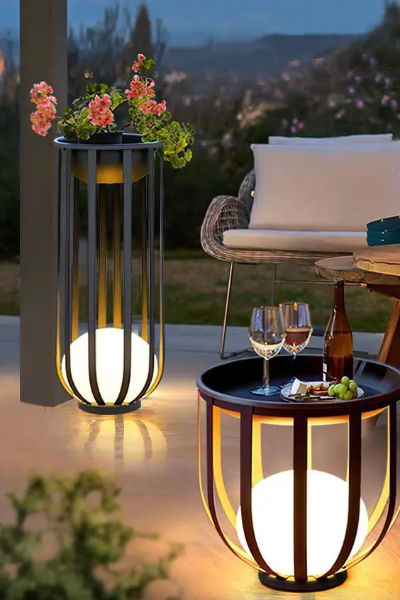 A planter stand and a side table with built in lamps are a cool way to illuminate the space without cluttering it