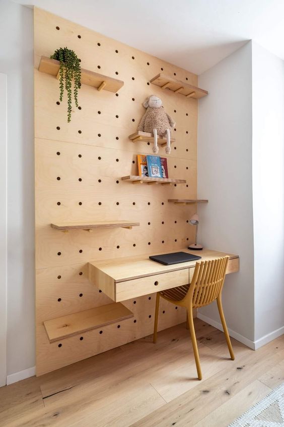 a small modern kids' study space with a pegboard and shelves, with some stuff, is a cool space to study and create