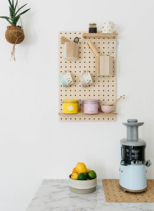 a small pegboard rack with various kitchen ware is a cool solution for a Scandinavian kitchen