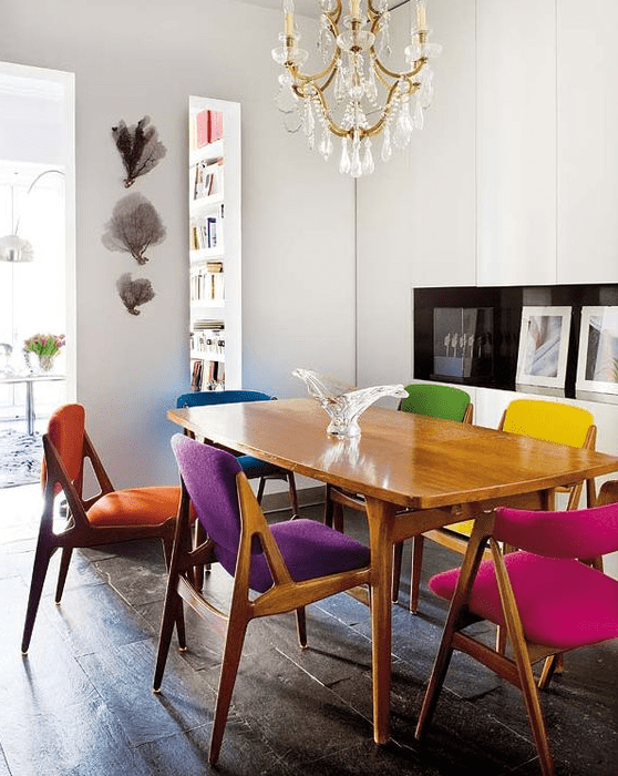 a stylish and cozy mid-century modern dining room with matching yet differently upholstered chairs
