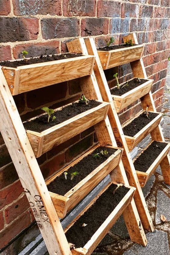 a vertical garden built of pallets, with planters as steps is a cool idea for a rustic space, and you can assemble one, too
