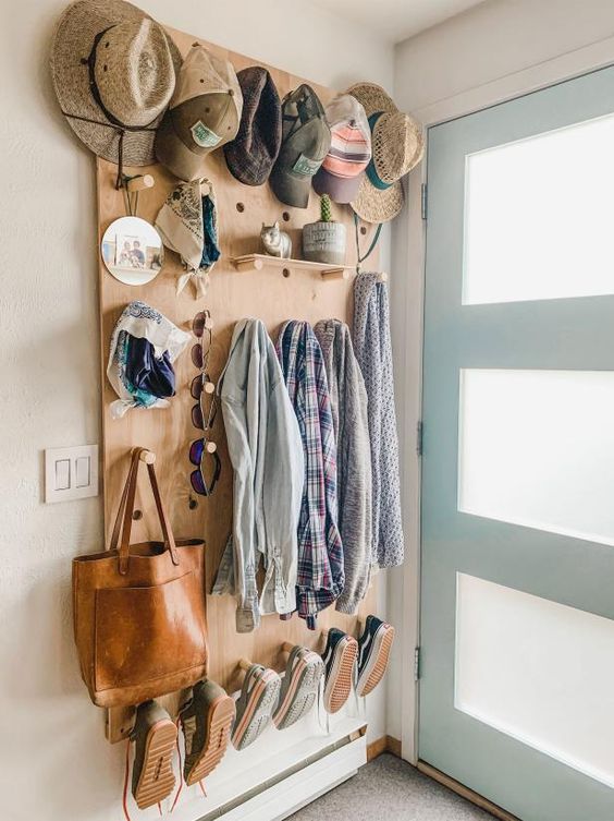 an entryway done with a large pegboard, with shelves and hooks is a smart and lovely idea, it saves a lot of space and makes it effective