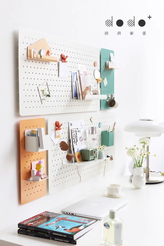 color block pegboards on the wall, wth shelves and hooks are great for a modern home office, they look stylish and are functional