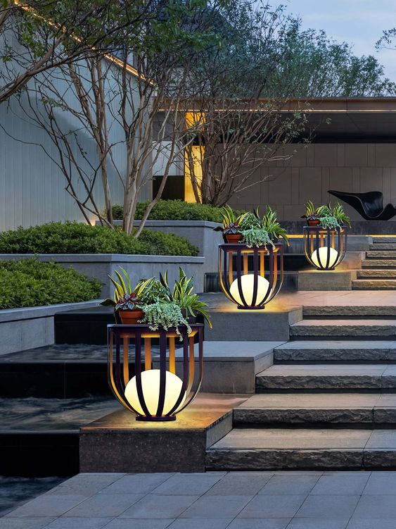 planter stands with lamps inside and plants on top are perfect to line up the staircase or some other space