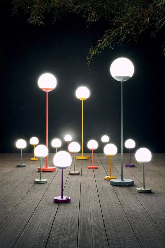 smaller and larger floor outdoor lamps with colorful stands are a cool idea for a modern or Scandinavian space