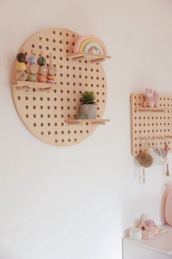 variously shaped pegboards with shelves are great decor for a kid's room, they look cute and work well