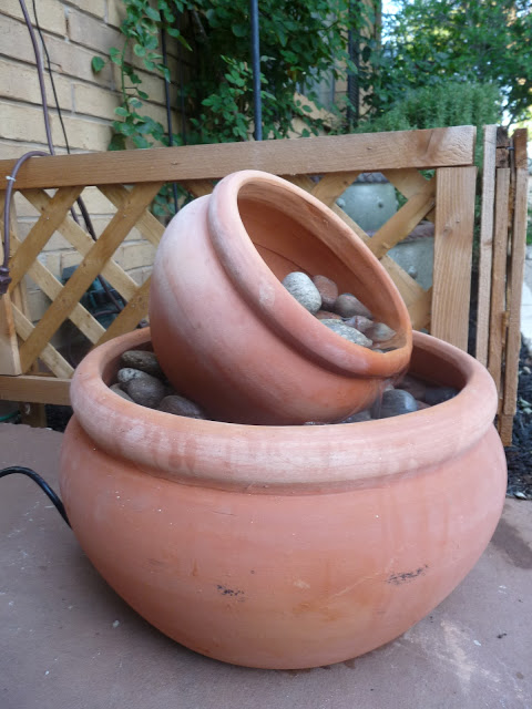 DIY flower pot fountain that costs $50 to make. (via thehappyhomebodies)