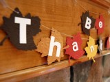 a bright fabric leaf garland with letters is all you need for decorating your home at Thanksgiving