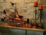 an elegant Halloween mantel with branches, lights, candles and faux blackbirds is very lovely decor