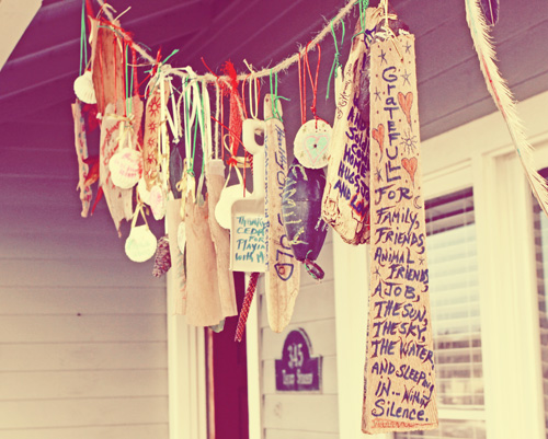 a boho gratitude garland for Thanksgiving with signs and tags can be hung over your porch or front door
