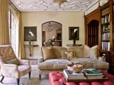 catchy ceiling molding is highlighted with traditional furniture and vintage artworks and bookcases