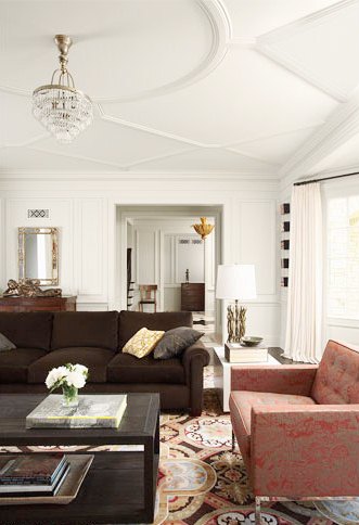 geometric molding on the ceiling and a round trim to highlight the chandelier and adds chic to the space