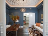 geometric molding on the ceiling and a matching sliding door add chic and style to the space