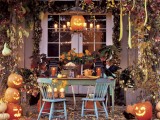 a bright classic Halloween terrace with lots of carved pumpkins, leaves, gourds, faux birds and Jack-o-lanterns