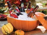 a drink cooler made of a pumpkin filled with ice will work not only for Halloween but also for the whole fall