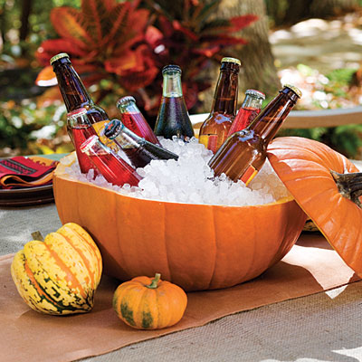 a drink cooler made of a pumpkin filled with ice will work not only for Halloween but also for the whole fall