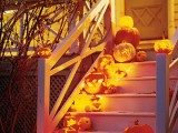 cover your staircase with lovely carved jack-o-lanterns to illuminate the way and make it Halloween-like